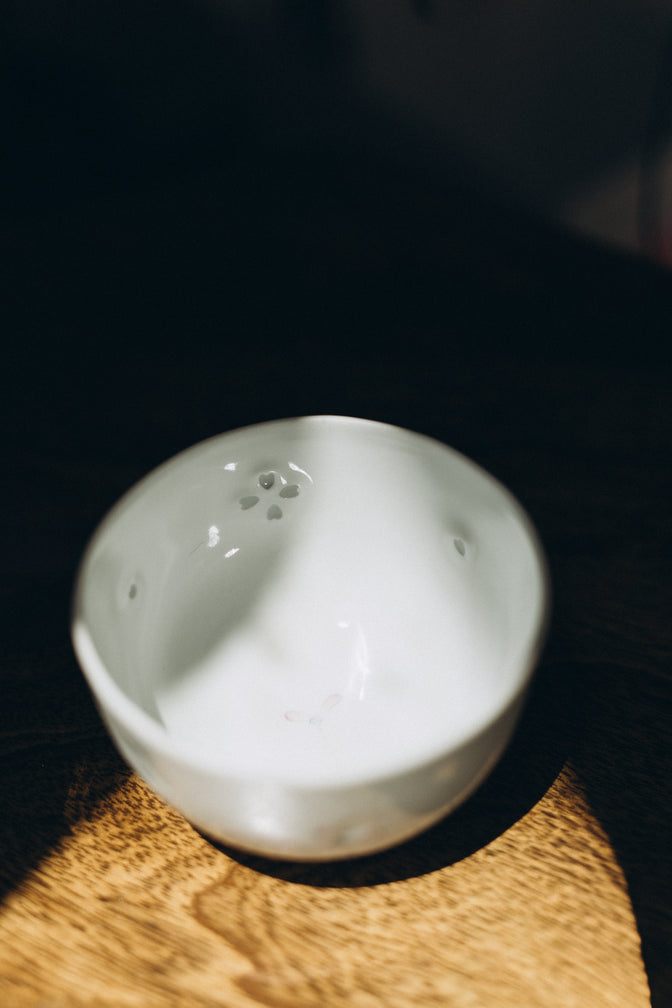 Dayflower porcelain teacup viewed from above on a wooden surface.
